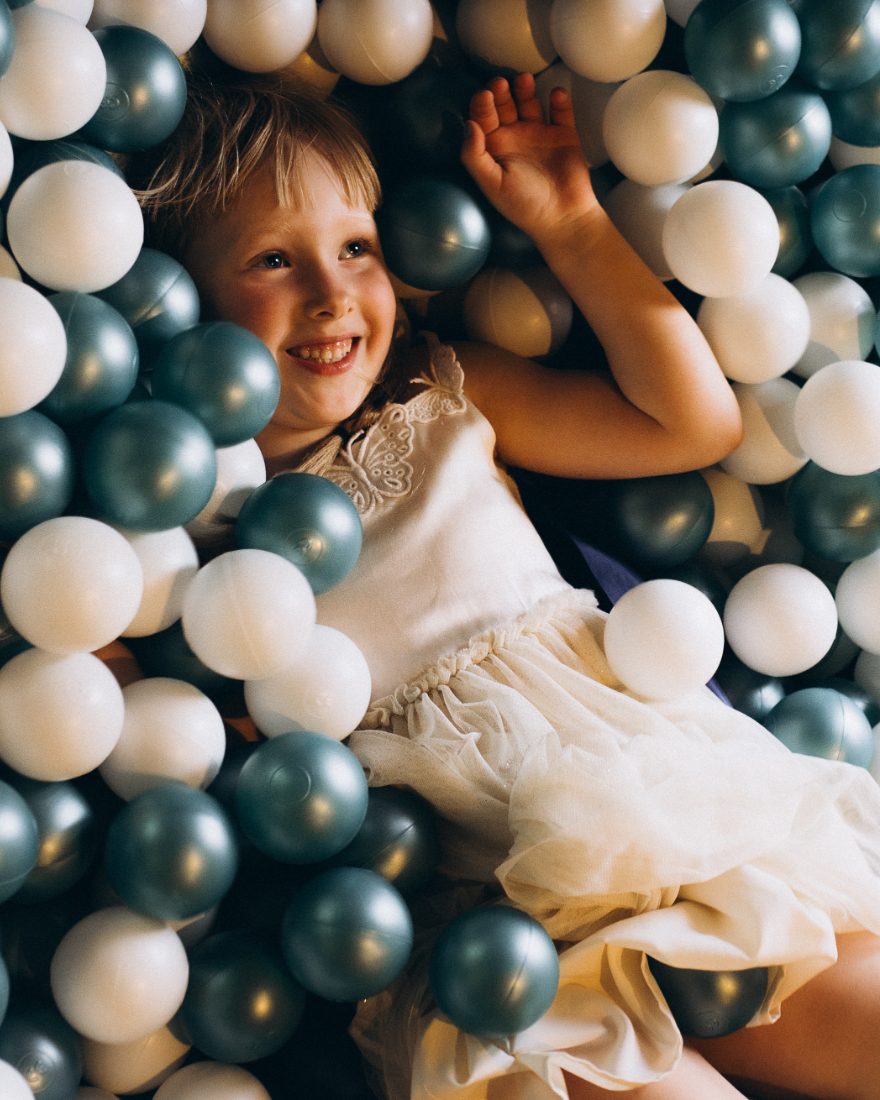A girl in the ball pit